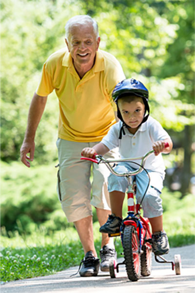 Elderly man playing with grandchild